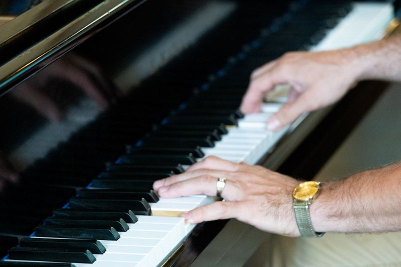 Close up of Roland playing the piano.