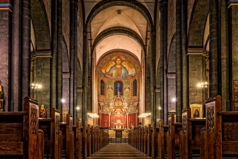 Image of the inside of a church with a painted ceiling.