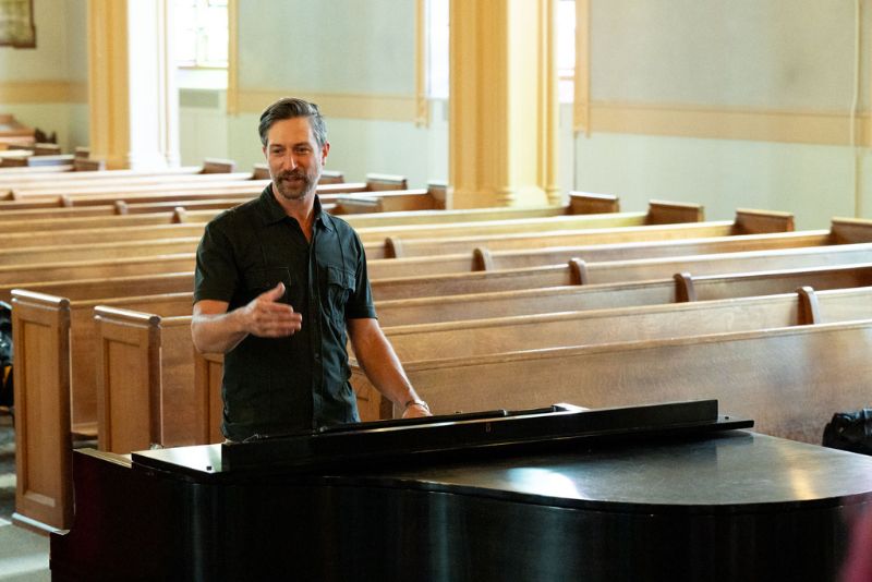 Roland Graham instructing choir students.